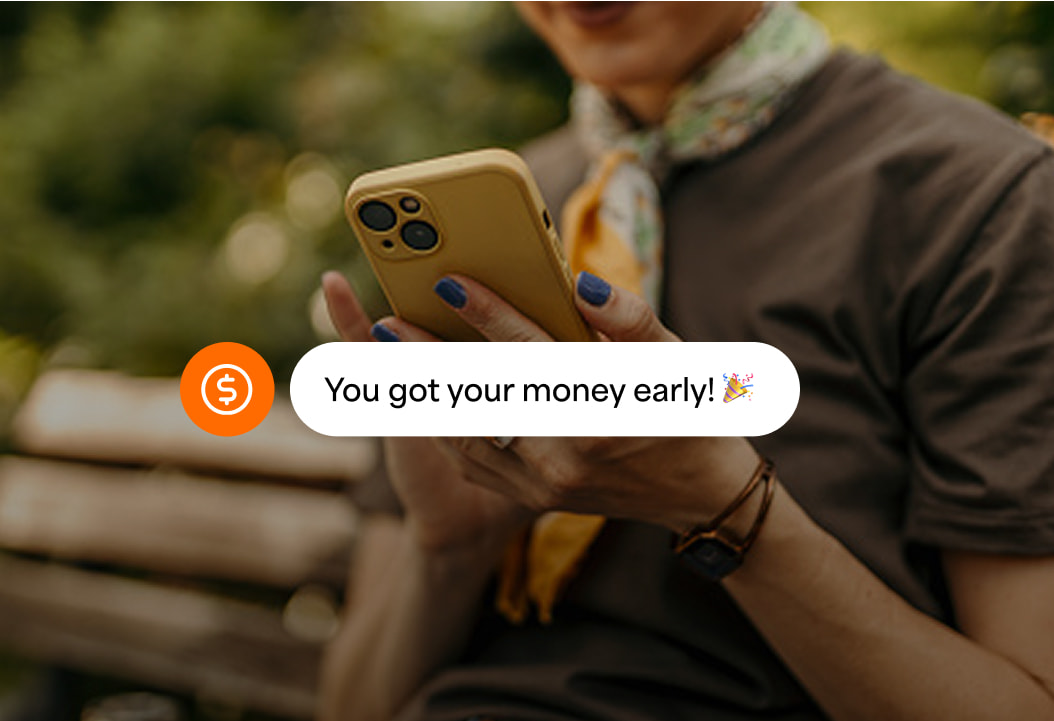 Person on a phone with a notification of getting their money early