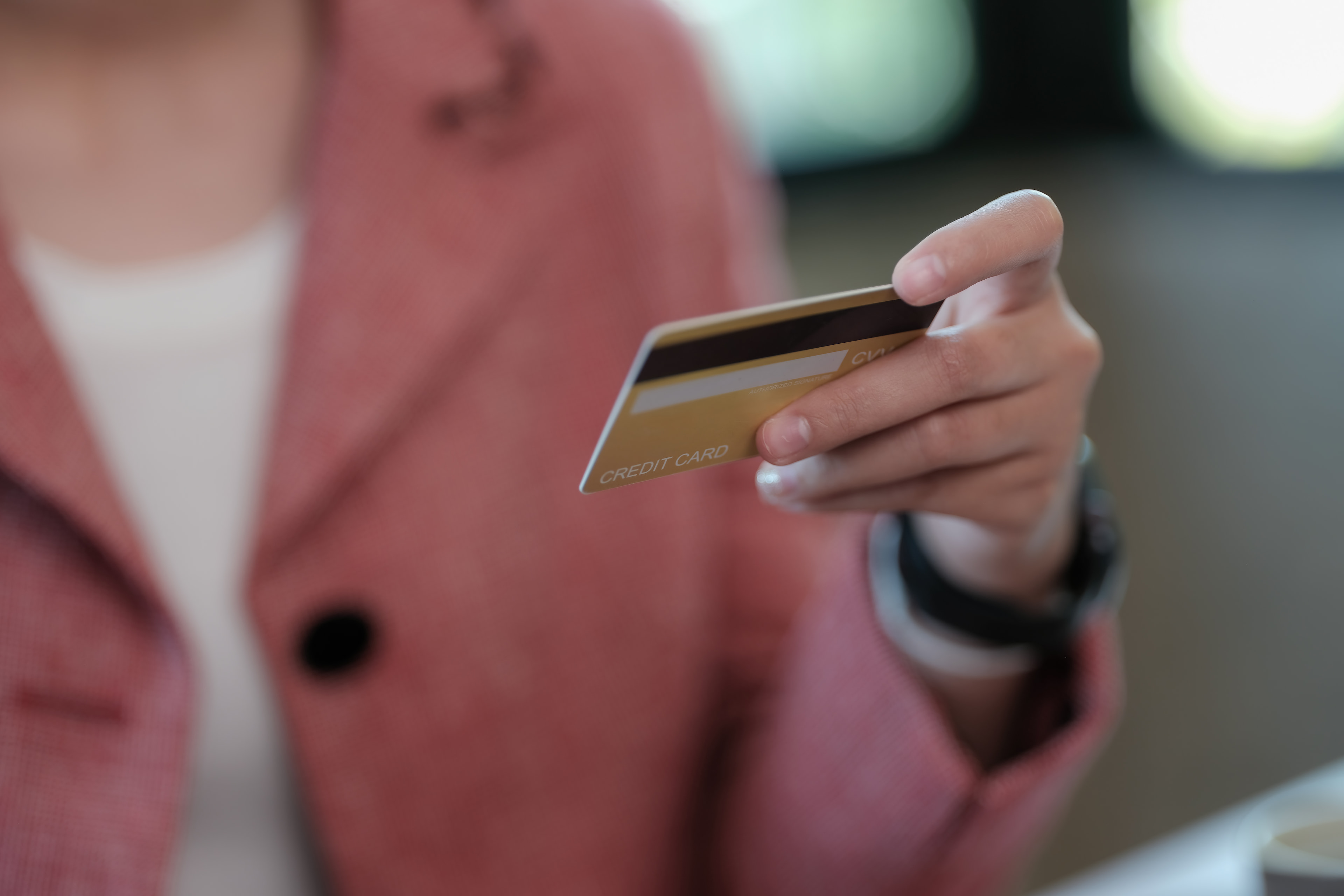 Holding a prepaid credit card in her hand.